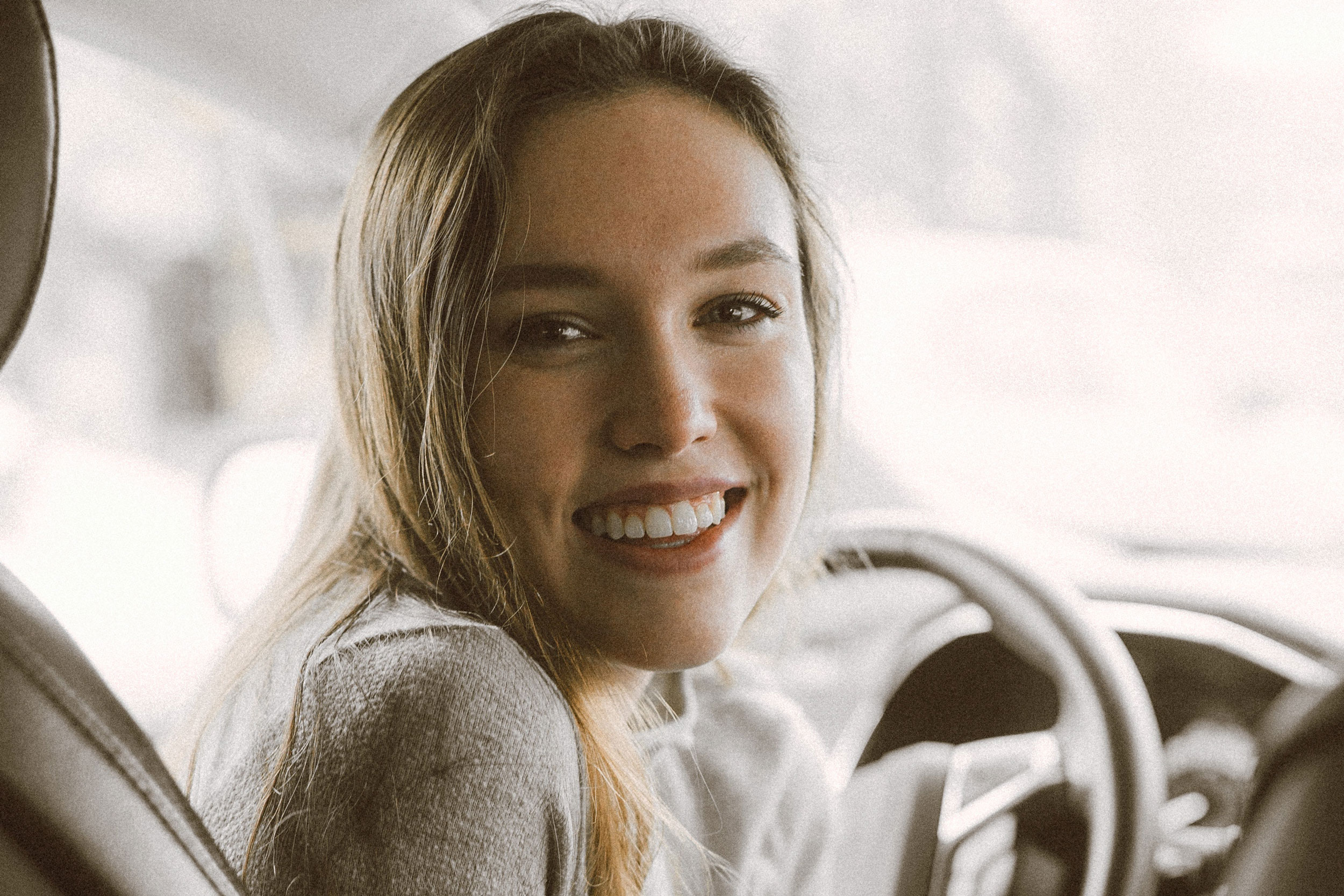 woman inside vehicle smiling
